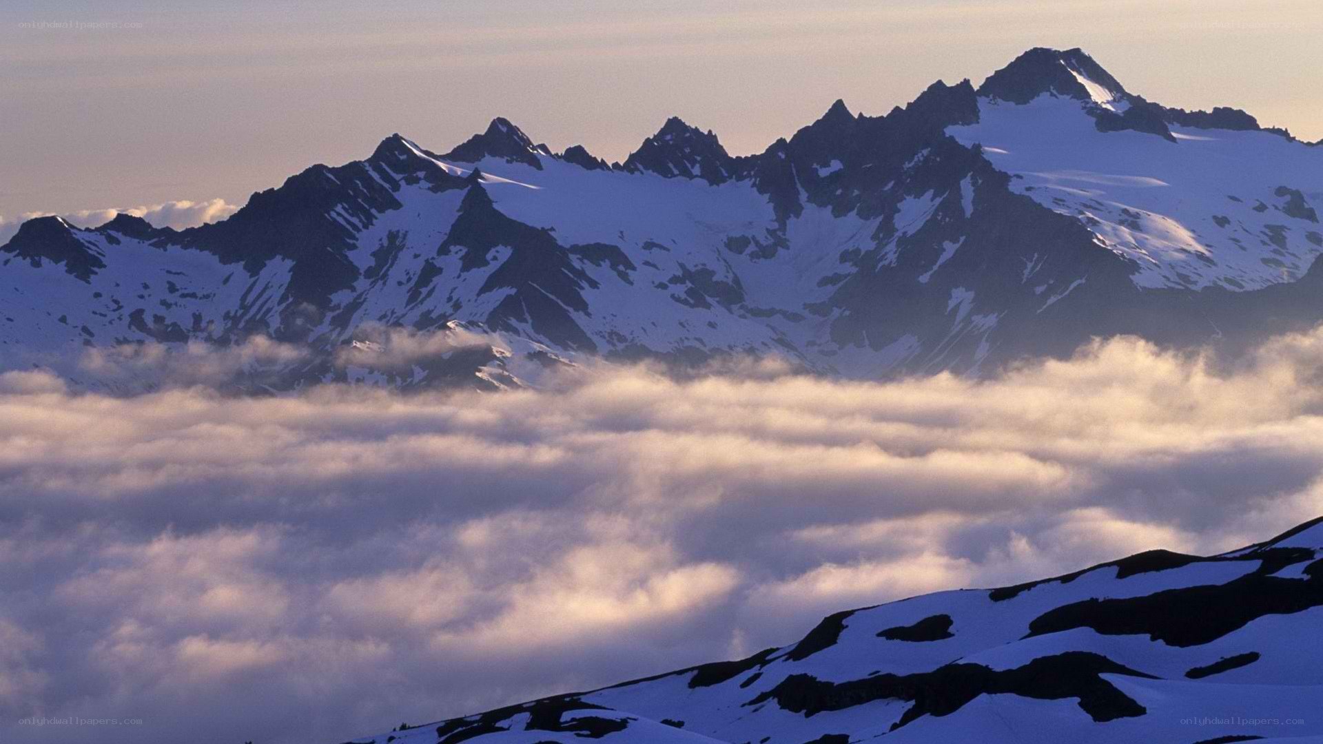snow-capped mountains above clouds