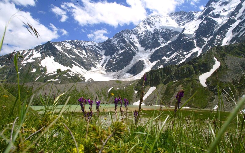 Snow-capped mountains and alpine lake