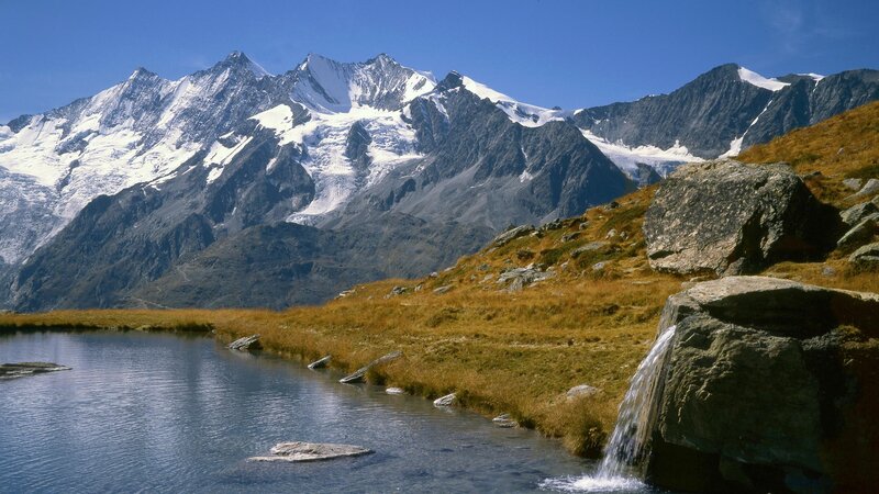 Snow-capped mountains and alpine lake