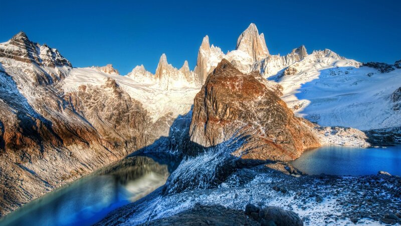 Snow-capped mountains and alpine lake