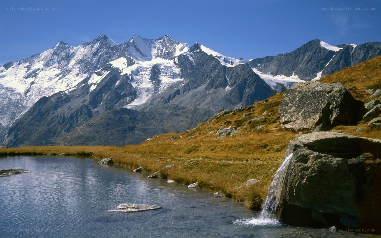Snow-capped mountains and alpine lake