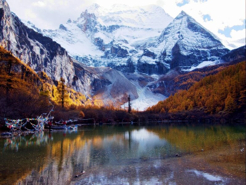 Snow-capped mountains and autumn lake