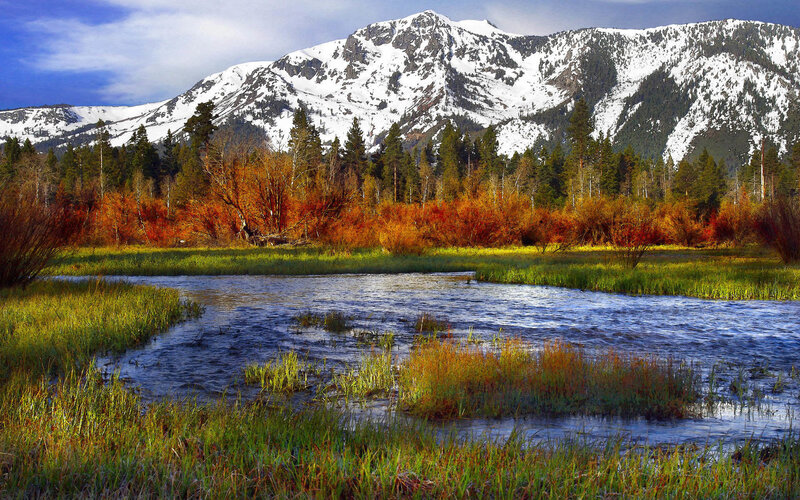 Snow-capped mountains and autumn river