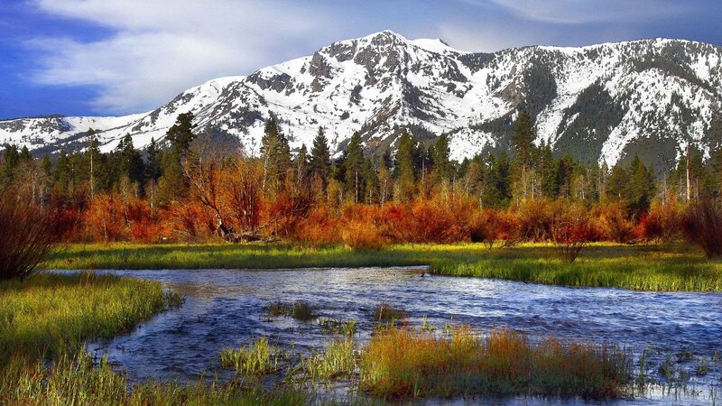 Snow-capped mountains and autumn river