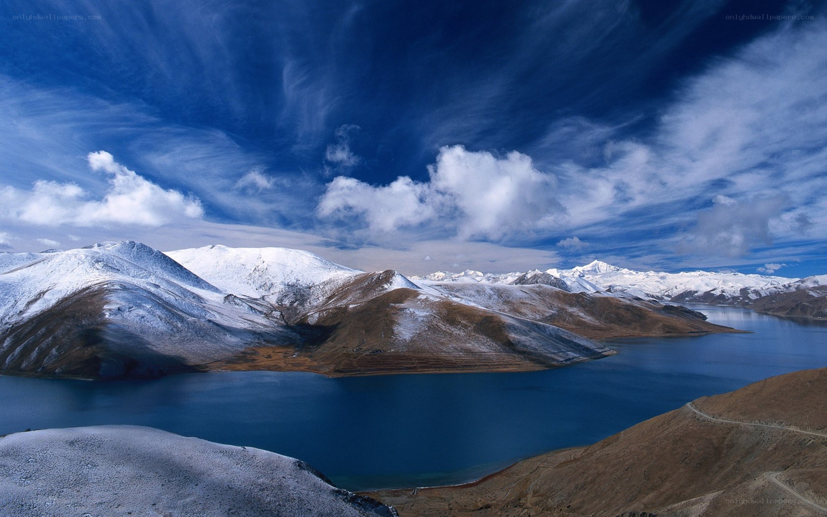 Snow-capped mountains and blue lake