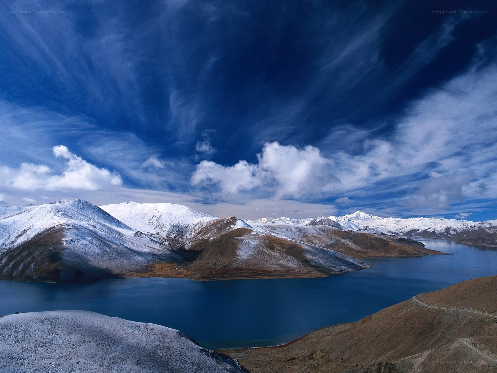 Snow-capped mountains and blue lake