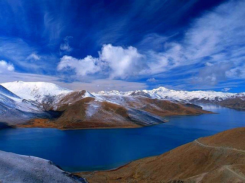 Snow-capped mountains and blue lake