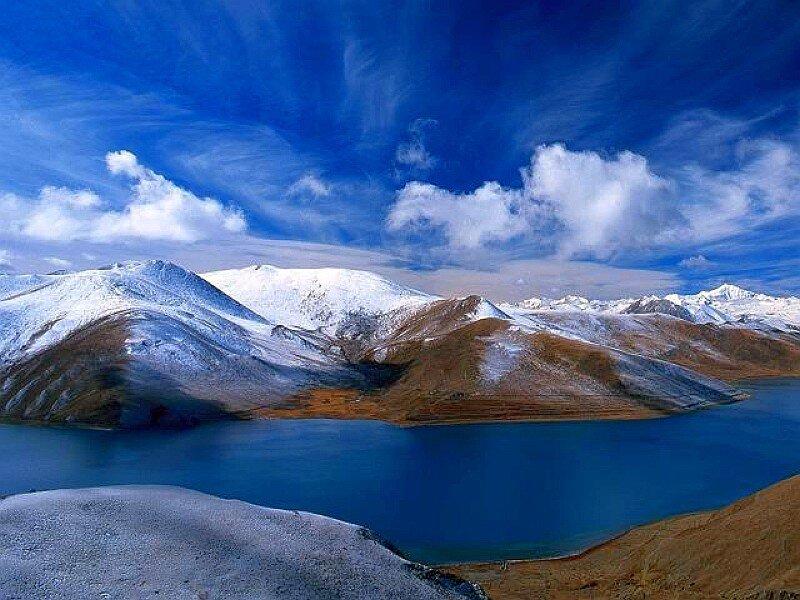 Snow-capped mountains and blue lake