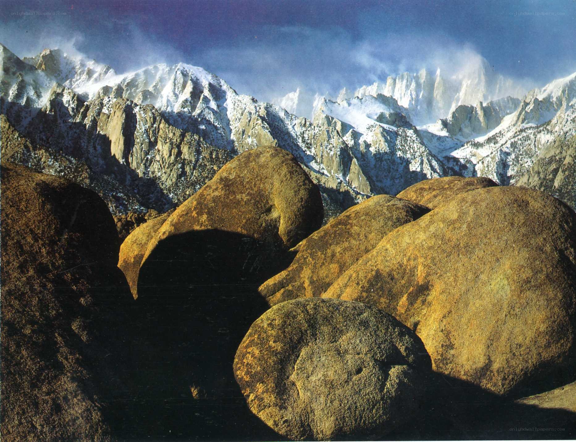Snow-capped mountains and boulders