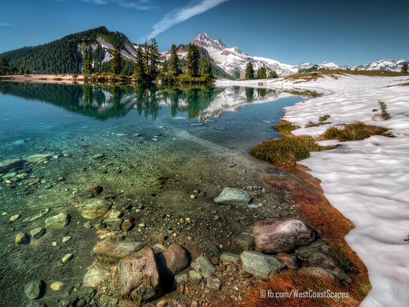 Snow-capped mountains and clear lake