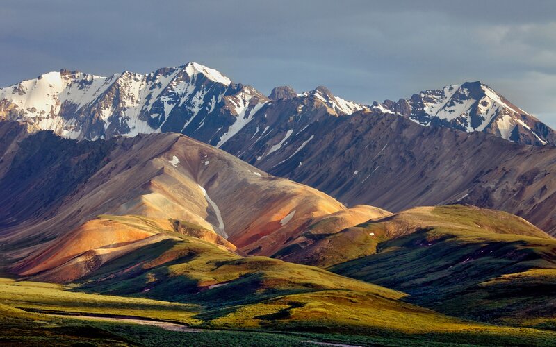 Snow-capped mountains and colorful hills