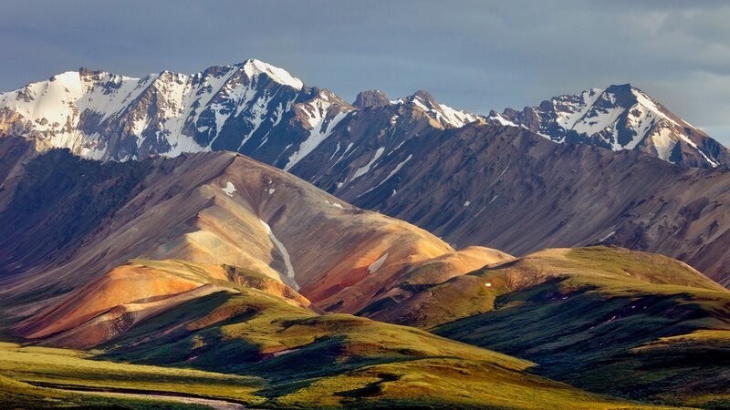 Snow-capped mountains and colorful hills