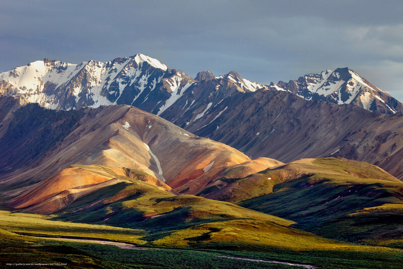 Snow-capped mountains and colorful hills