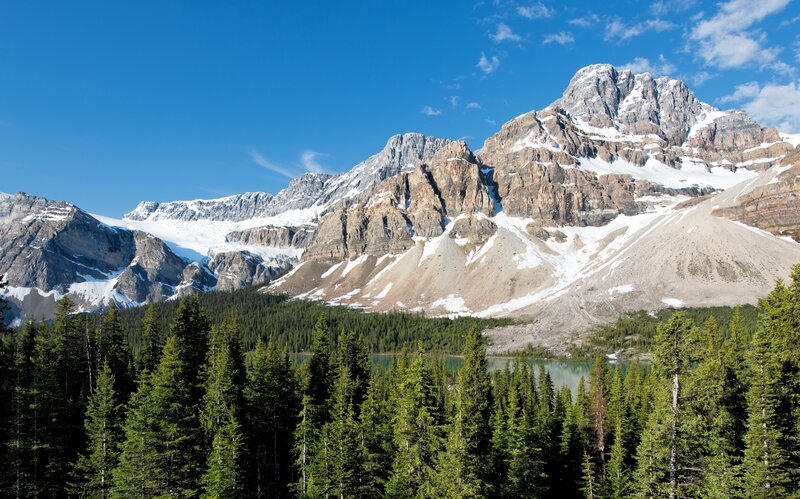 Snow-capped mountains and forest lake