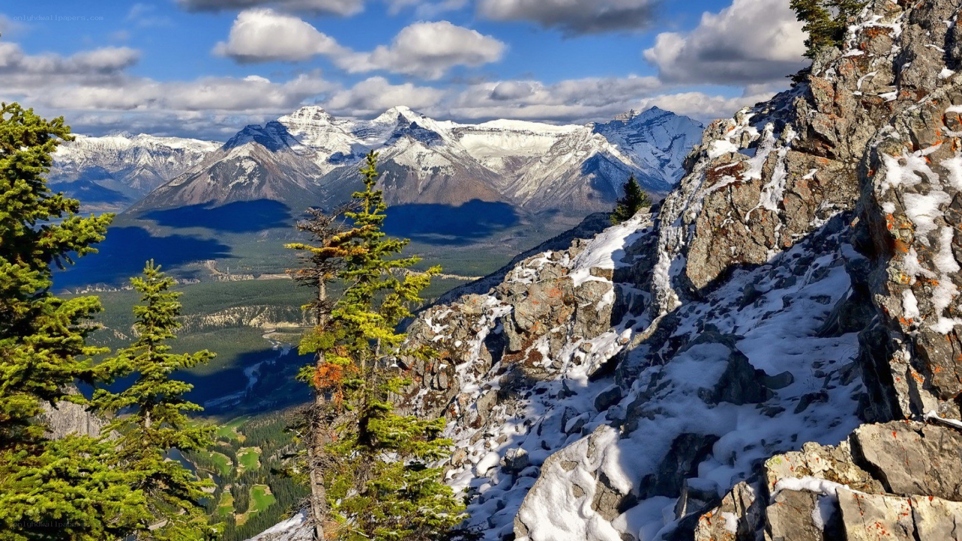 Snow-capped mountains and forest valley