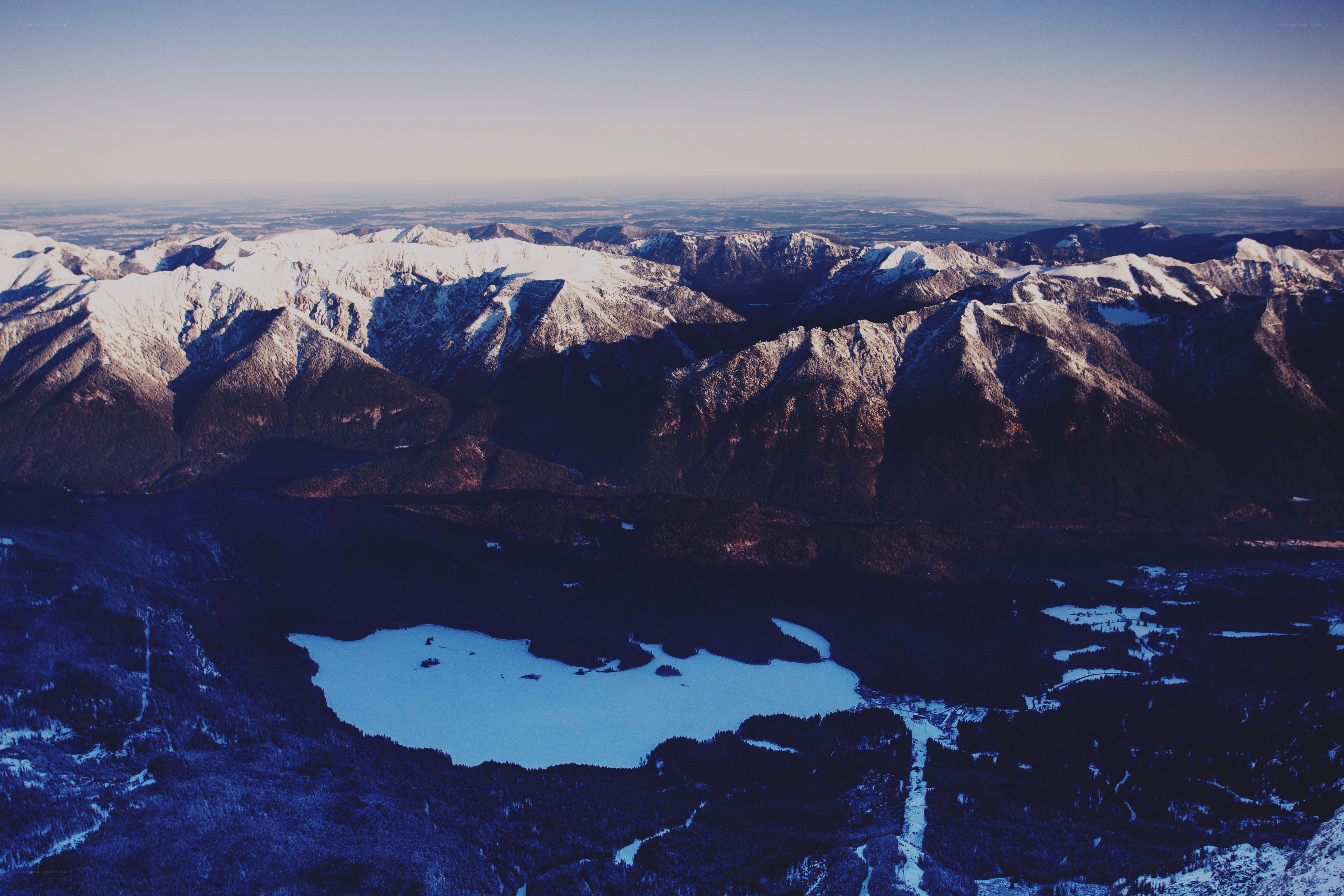 snow-capped mountains and frozen lake