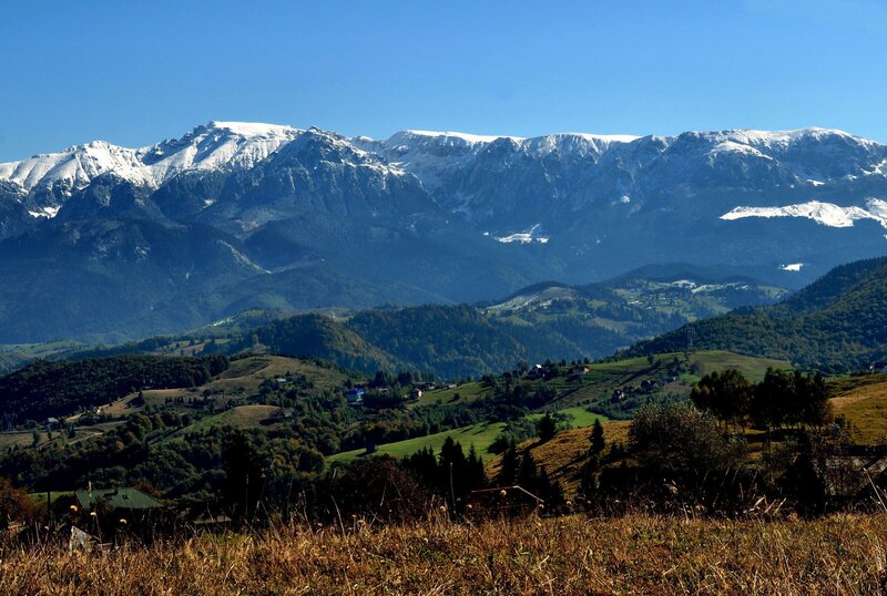 Snow-capped mountains and green hills