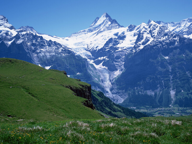 Snow-capped mountains and green hills