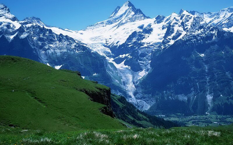 snow-capped mountains and green hills