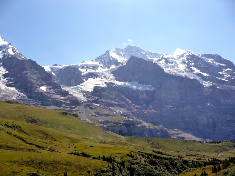 snow-capped mountains and green hills