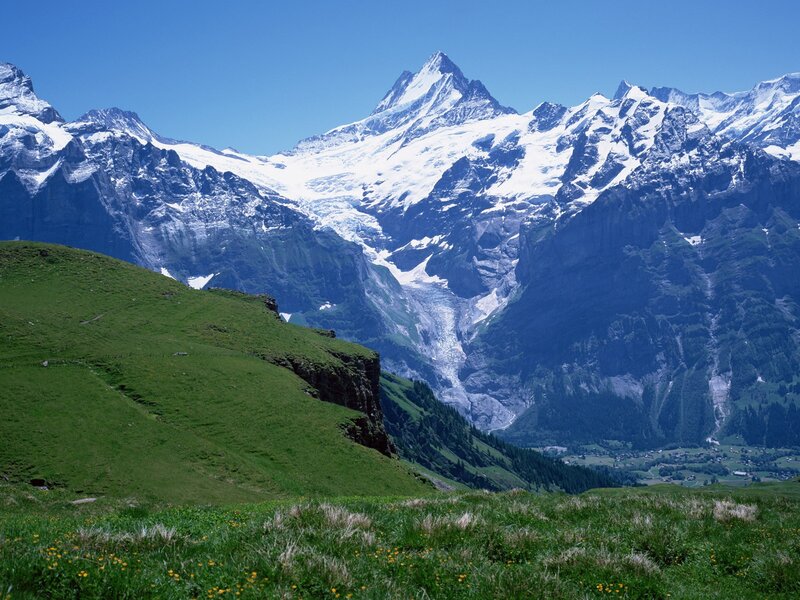 Snow-capped mountains and green hills