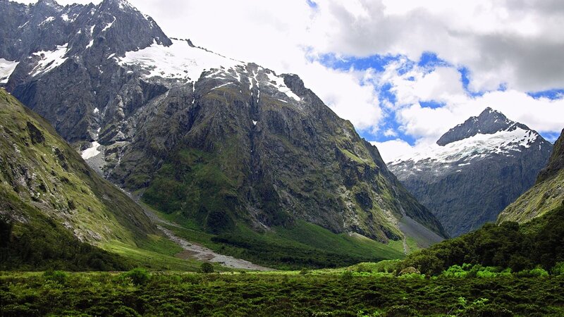 snow-capped mountains and green valley