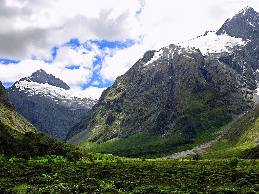 snow-capped mountains and green valley