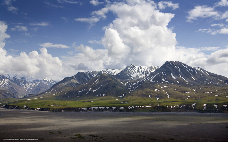 Snow-capped mountains and green valley