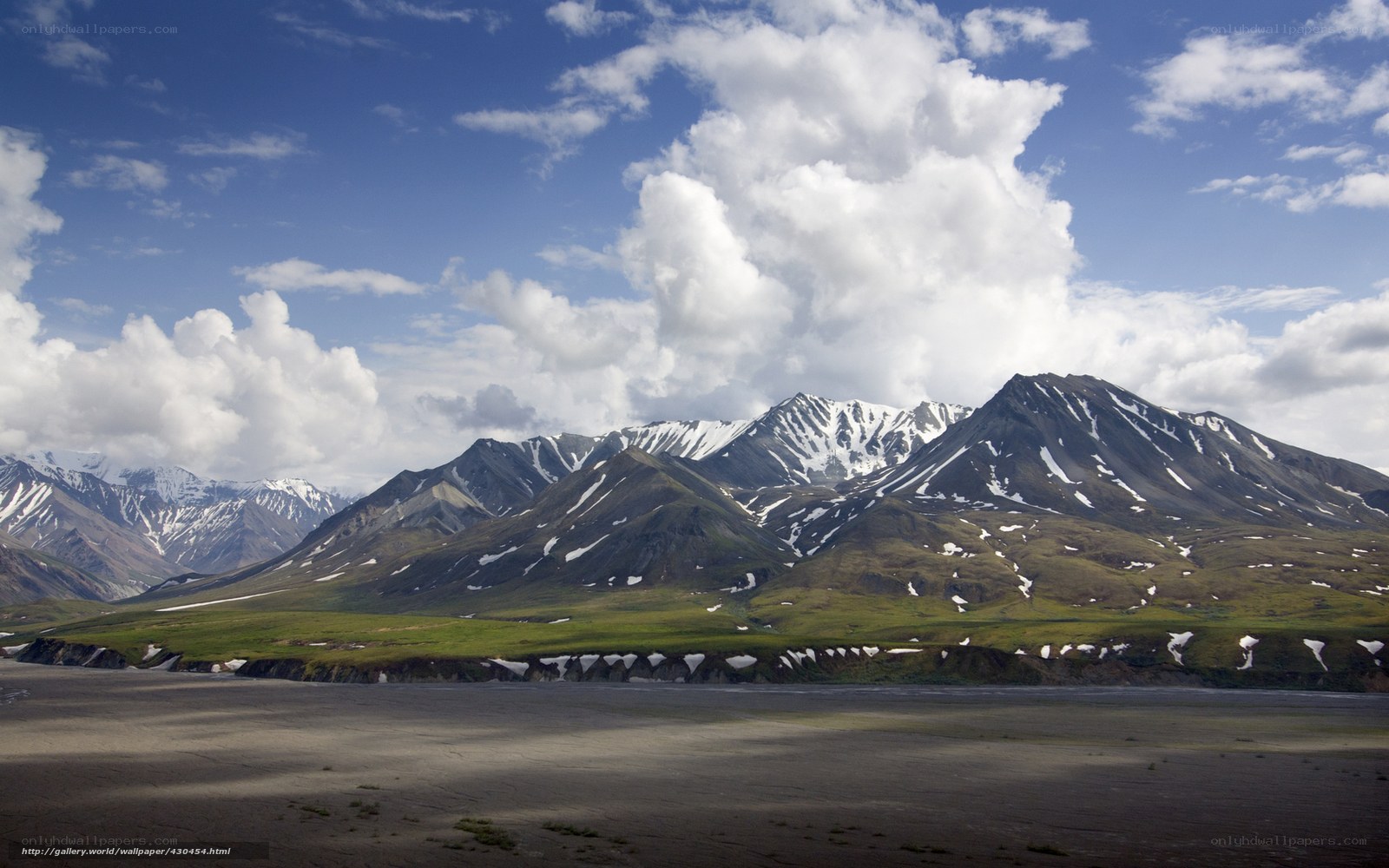 Snow-capped mountains and green valley
