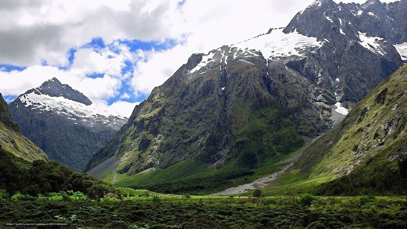 snow-capped mountains and green valley