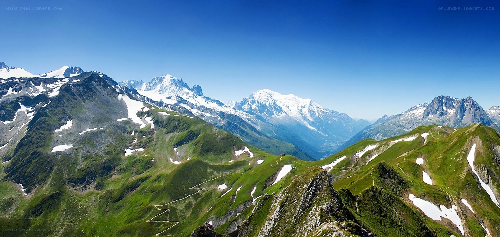 snow-capped mountains and green valleys