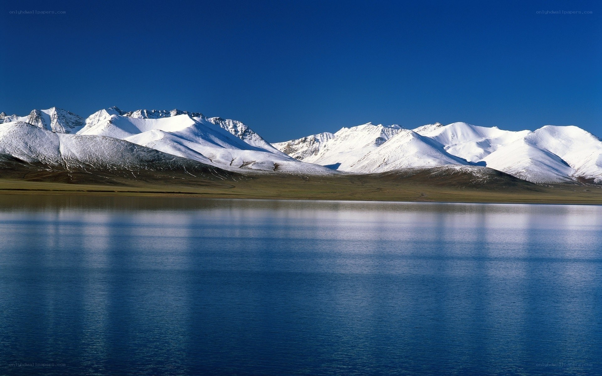 Snow-capped mountains and lake