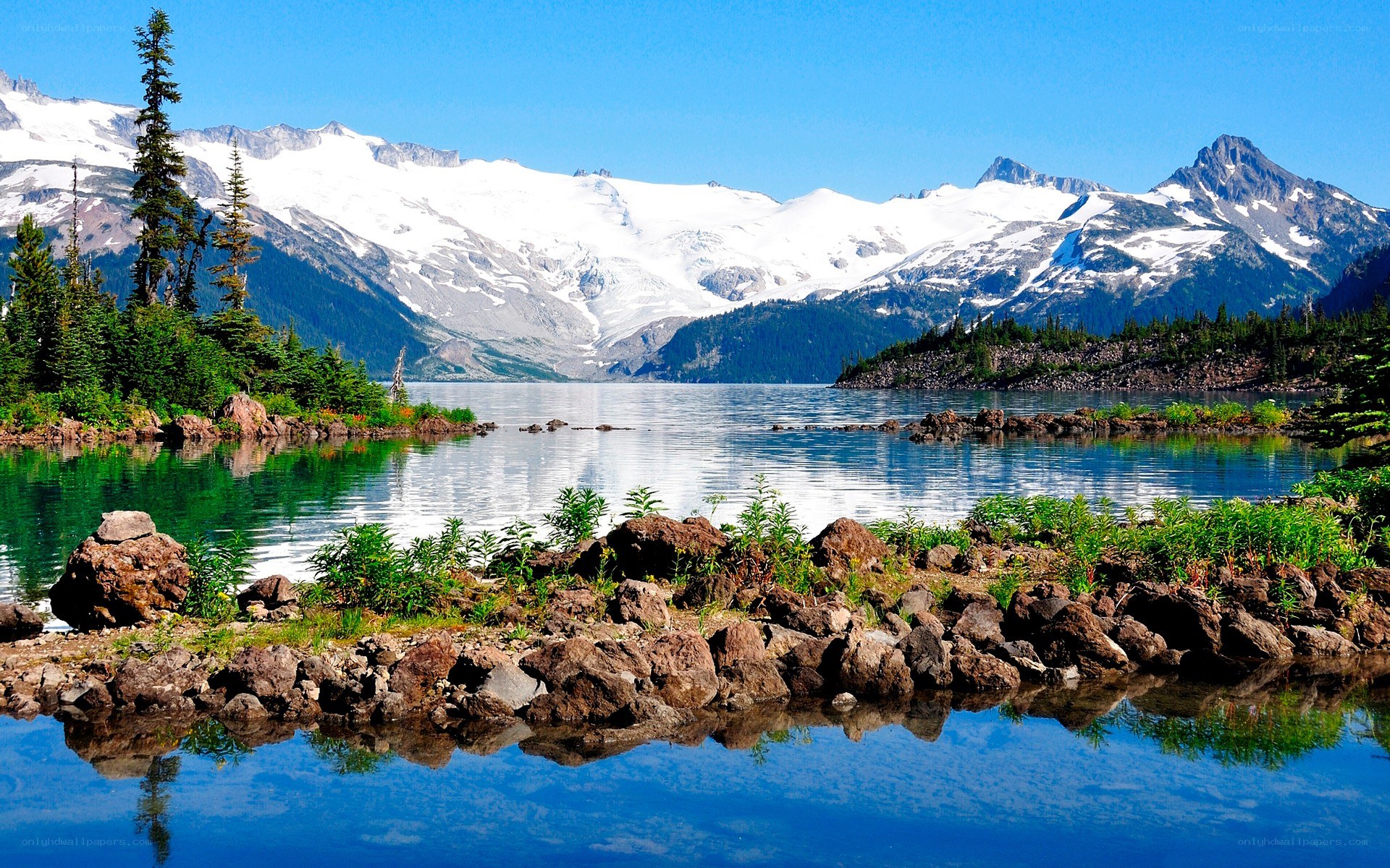 Snow-capped mountains and lake