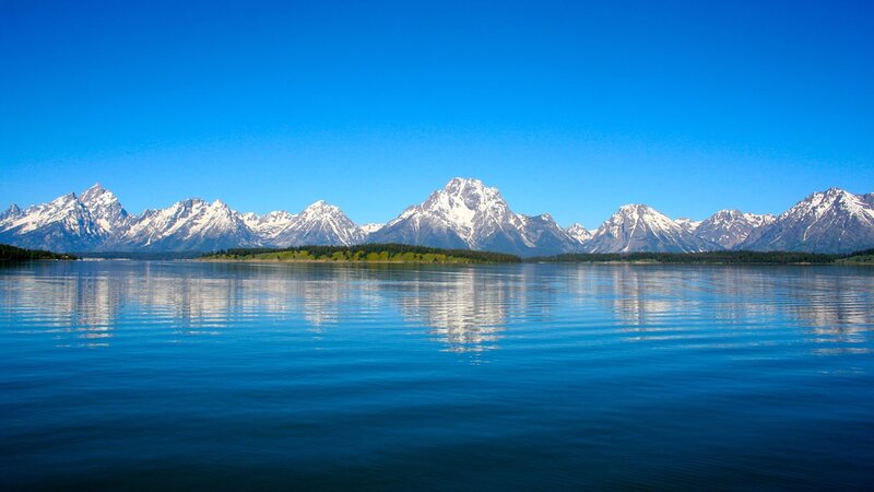 snow-capped mountains and lake