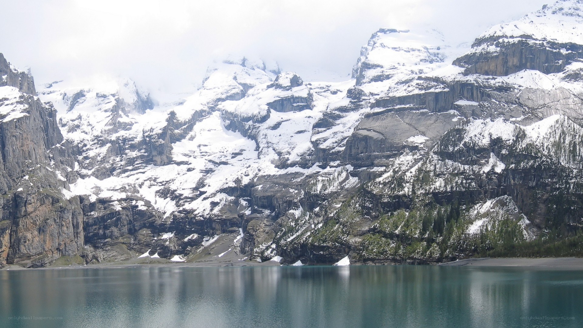 snow-capped mountains and lake