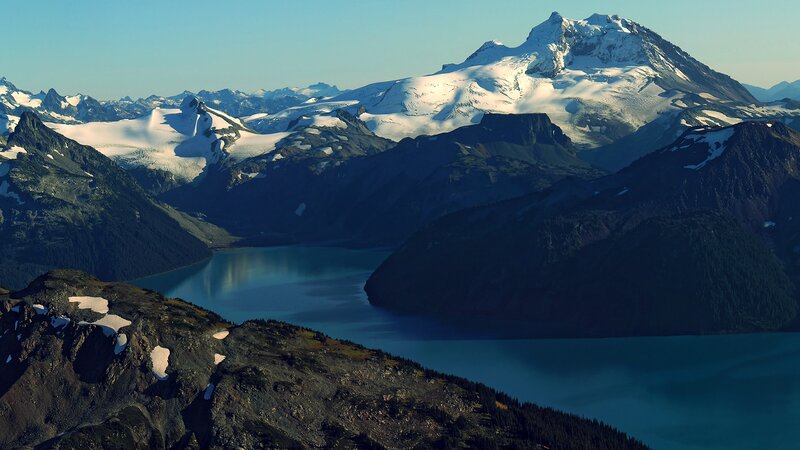 snow-capped mountains and lake