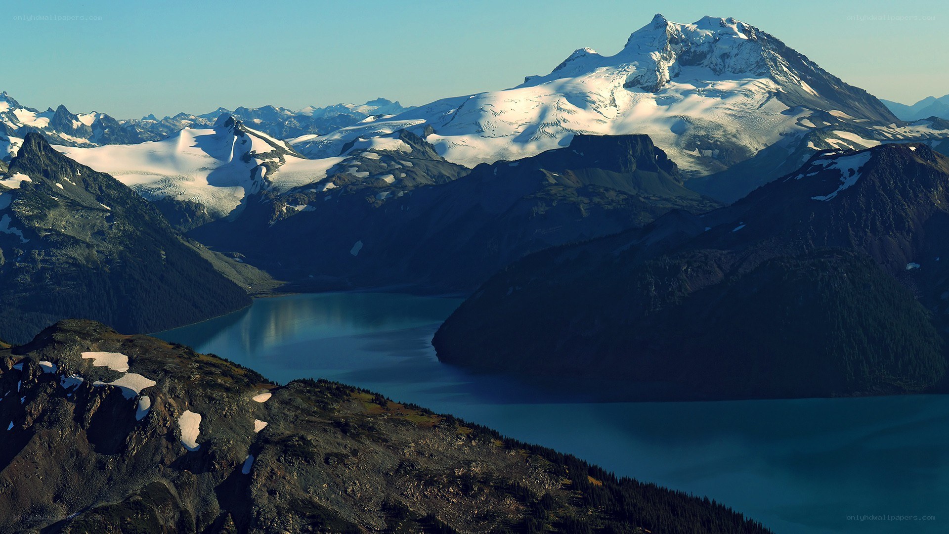 snow-capped mountains and lake
