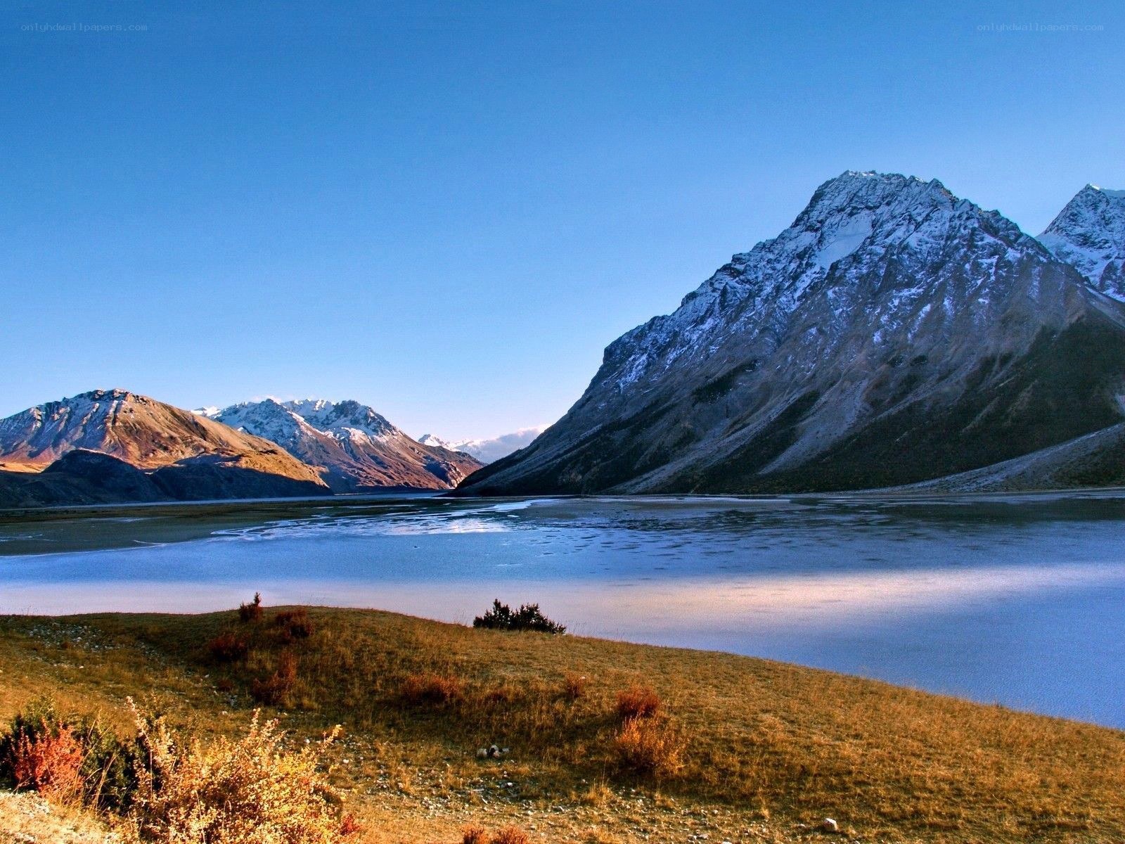 Snow-capped mountains and lake