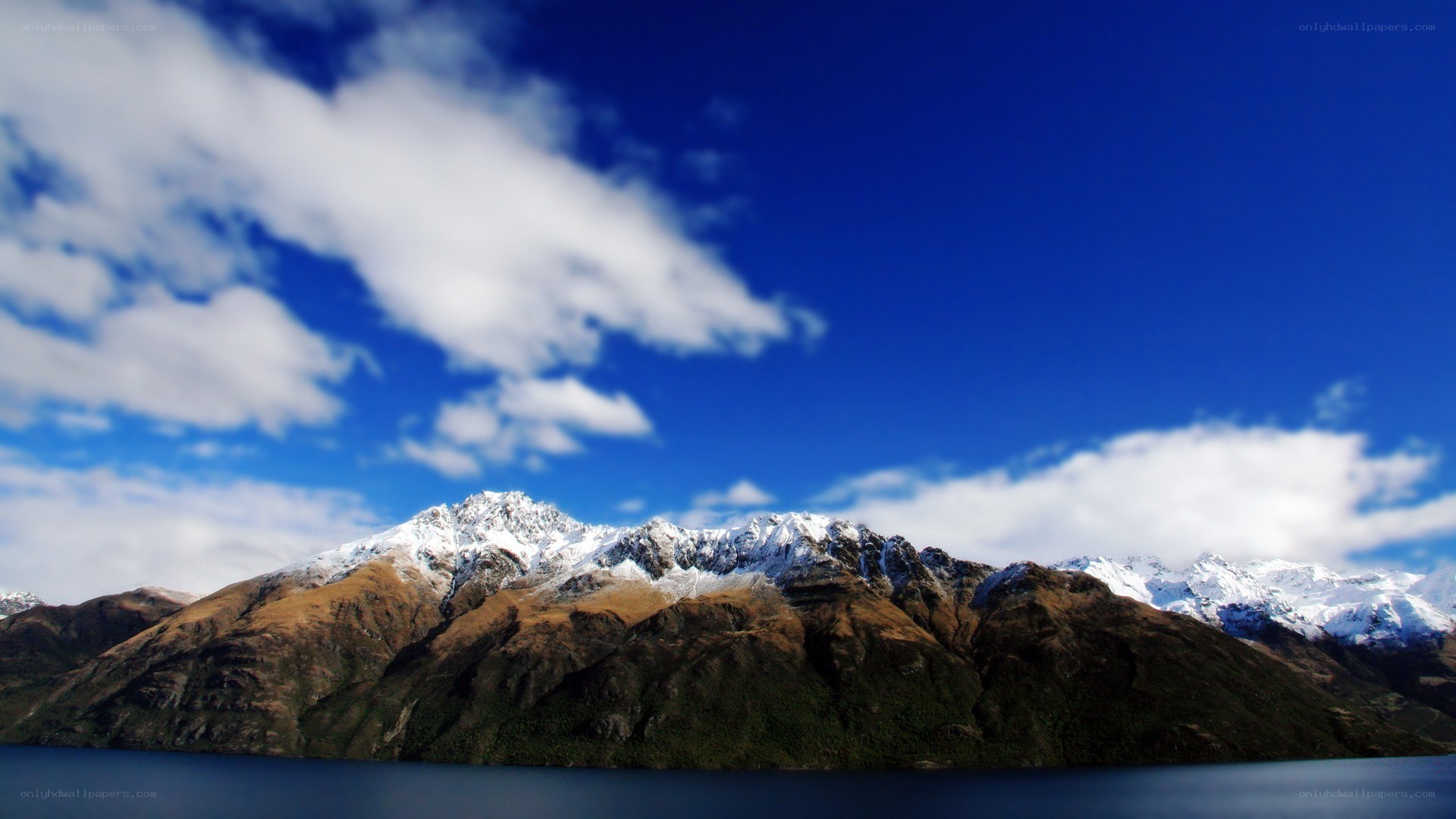 snow-capped mountains and lake