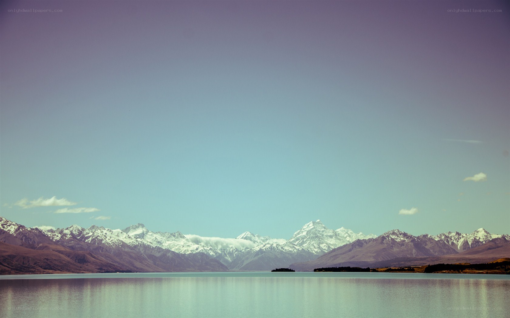 snow-capped mountains and lake