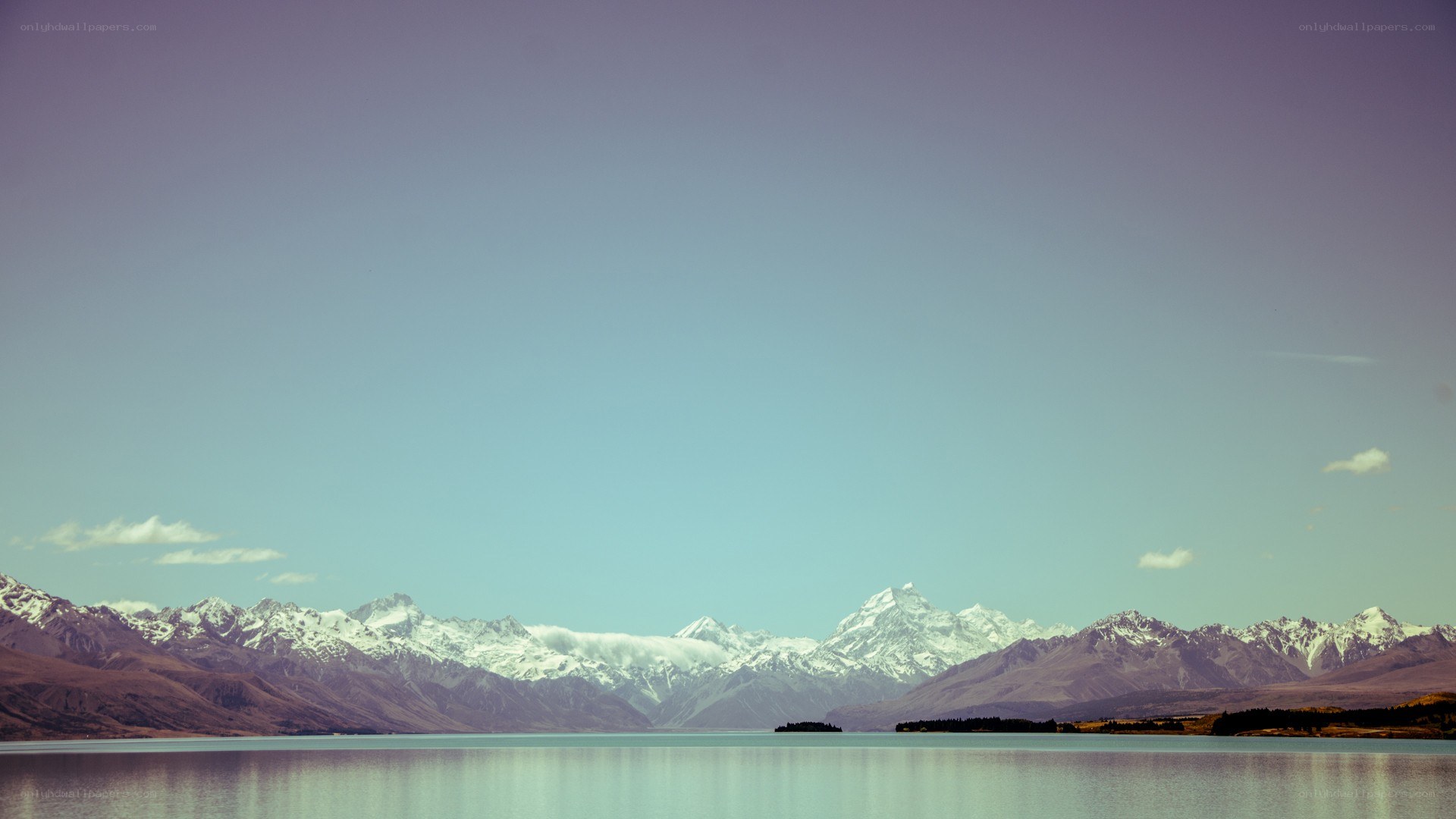 snow-capped mountains and lake