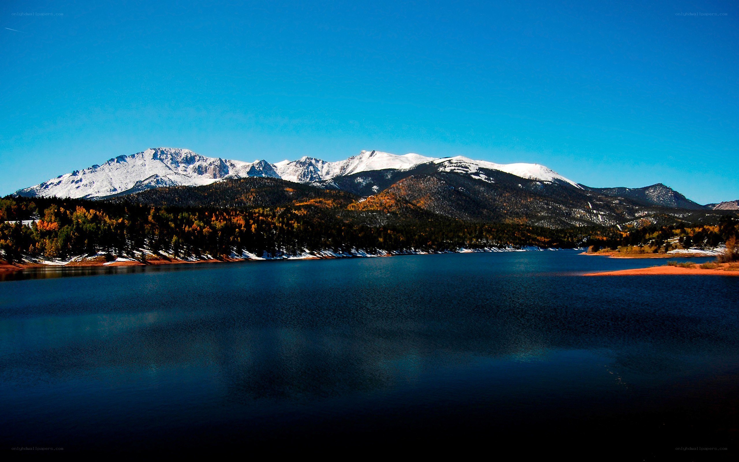 Snow-capped mountains and lake