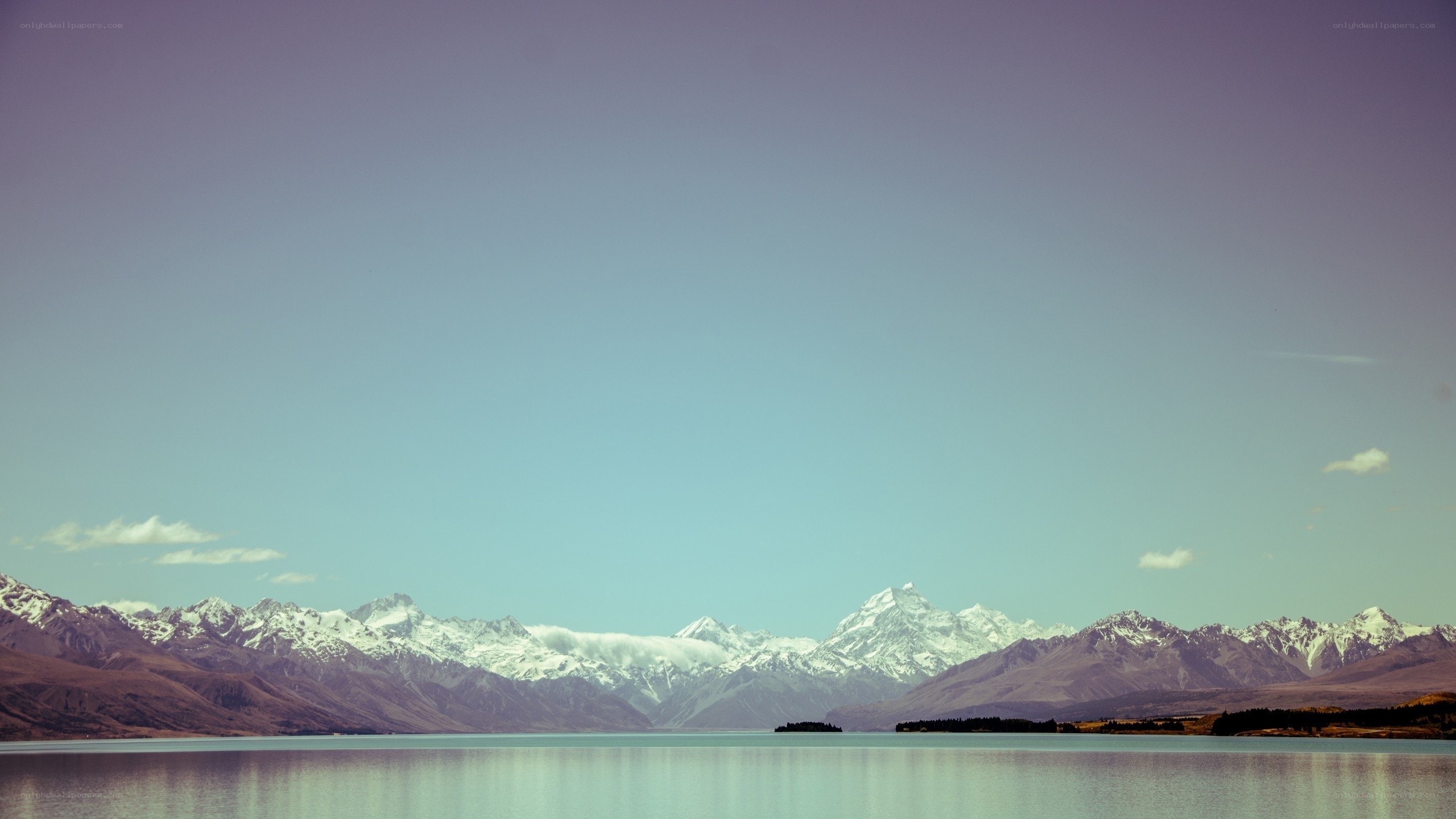 snow-capped mountains and lake