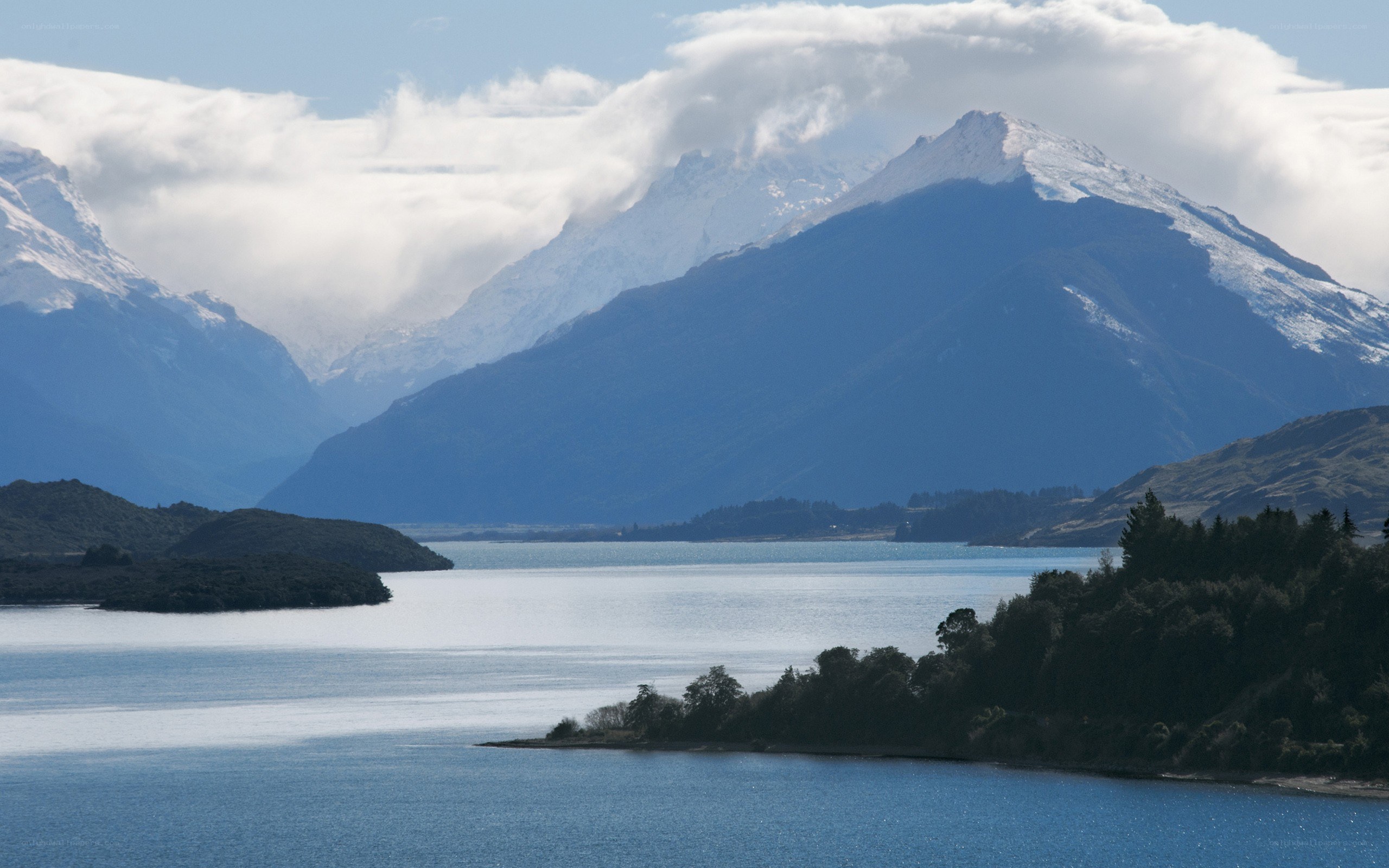 snow-capped mountains and lake