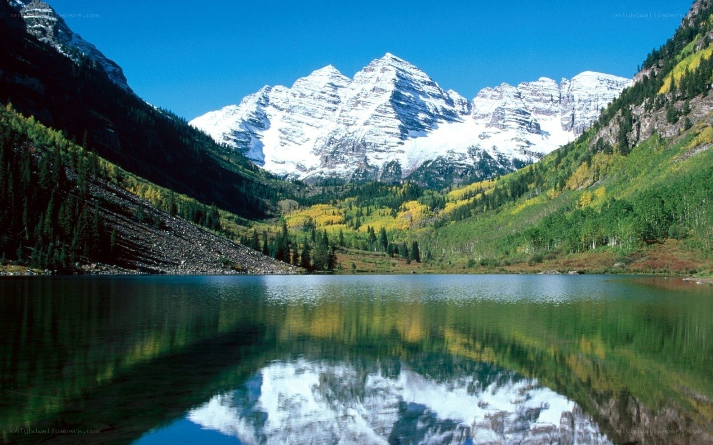 snow-capped mountains and lake