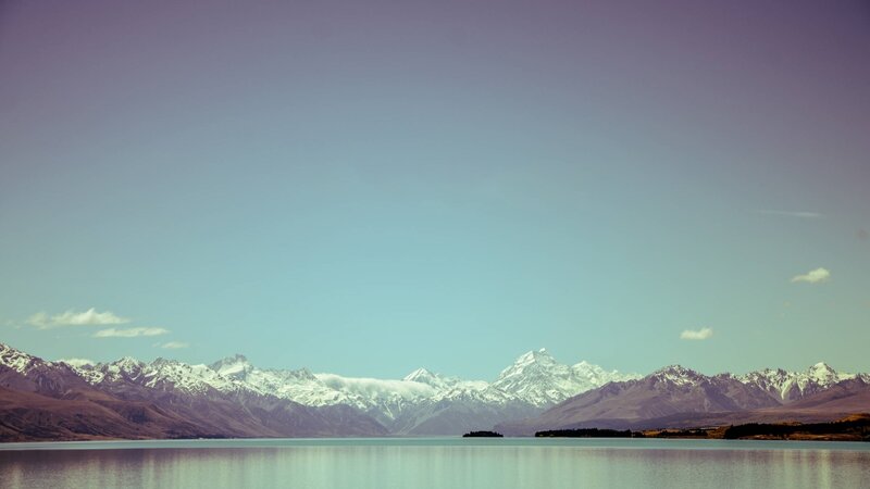 snow-capped mountains and lake