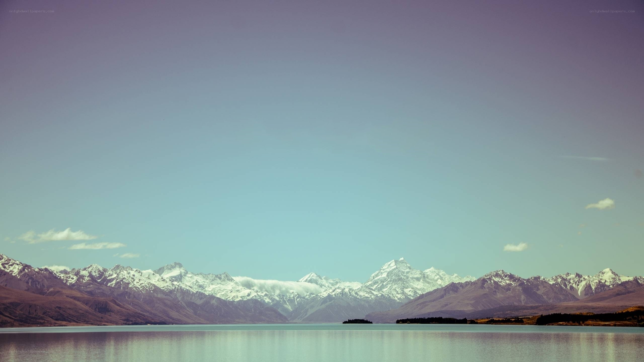 snow-capped mountains and lake