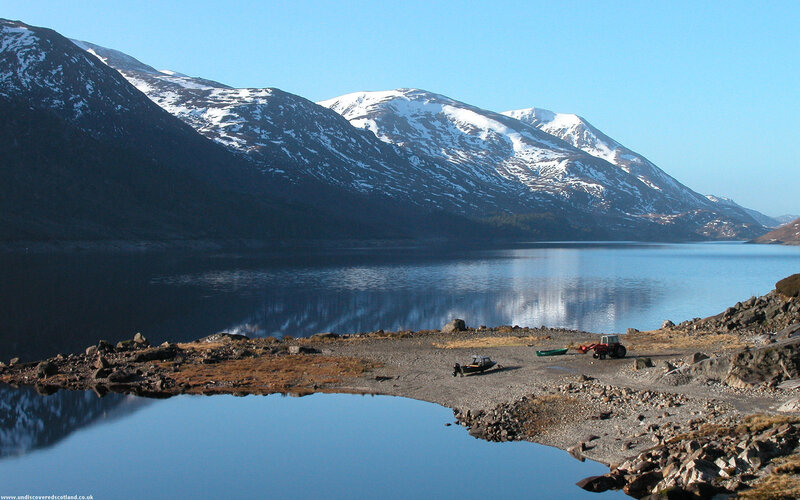 snow-capped mountains and lake