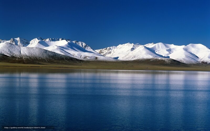 Snow-capped mountains and lake