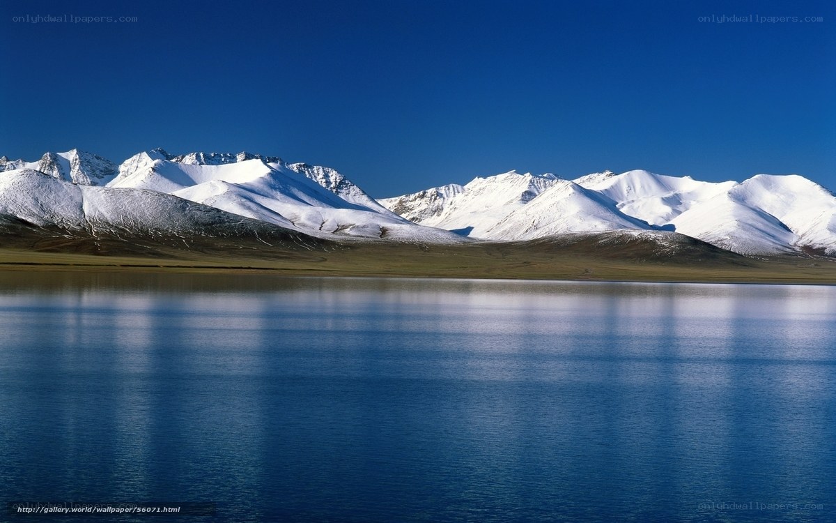 Snow-capped mountains and lake